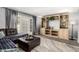 Cozy living room featuring a built-in entertainment center and access to outdoor living at 2121 W Union Hills Dr # 113, Phoenix, AZ 85027