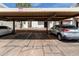 Assigned covered parking area featuring parking spots, shade and apartment complex at 2121 W Union Hills Dr # 113, Phoenix, AZ 85027