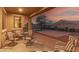Covered patio with comfortable seating area and view of the basketball court at sunset at 2324 W Melody Dr, Phoenix, AZ 85041