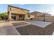 Spacious backyard featuring a basketball court, covered patio, and beautifully landscaped gravel accents at 2324 W Melody Dr, Phoenix, AZ 85041