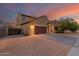 Two-story home featuring a two car garage, desert landscaping, and a fenced yard at 2324 W Melody Dr, Phoenix, AZ 85041