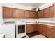Bright laundry area featuring modern appliances, a sink, cabinets, and ample counter space for convenience at 2324 W Melody Dr, Phoenix, AZ 85041