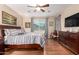 Spacious main bedroom features hardwood floors, a ceiling fan, and a large window for lots of light at 2324 W Melody Dr, Phoenix, AZ 85041
