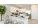 Modern kitchen featuring white cabinets, stainless steel appliances, and a breakfast bar with seating at 23362 W Atlanta Ave, Buckeye, AZ 85326