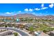 Aerial view of a community with a lake and mountain views in the background at 2387 E Runaway Bay Pl, Gilbert, AZ 85298