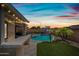 Outdoor living area with a pool, grilling area, and basketball court, ideal for entertaining at 2387 E Runaway Bay Pl, Gilbert, AZ 85298