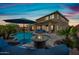 Outdoor entertaining area with pool, fire pit, grilling area and a basketball hoop, great for entertaining at 2387 E Runaway Bay Pl, Gilbert, AZ 85298