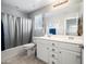 Bathroom featuring tiled floors, shower-tub combo, and a vanity with drawers and cabinet space at 2387 E Runaway Bay Pl, Gilbert, AZ 85298