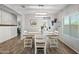 Bright dining room with decorative light fixture, farmhouse decor, and wood-look tile floors at 2387 E Runaway Bay Pl, Gilbert, AZ 85298
