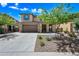 Charming two-story home with a stone-accented facade and a well-manicured front yard at 2387 E Runaway Bay Pl, Gilbert, AZ 85298