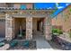 Inviting front porch with stone pillars and stylish decor at 2387 E Runaway Bay Pl, Gilbert, AZ 85298