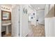 Inviting hallway with stylish decor, decorative floor tiles in the bathroom, and wood-look tile floors at 2387 E Runaway Bay Pl, Gilbert, AZ 85298