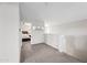 Upstairs hallway with a view into a carpeted bedroom and staircase at 2387 E Runaway Bay Pl, Gilbert, AZ 85298