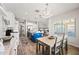Open-concept kitchen with white cabinetry, a blue island, stainless steel appliances, and adjacent dining area at 2387 E Runaway Bay Pl, Gilbert, AZ 85298
