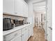 Bright kitchen boasts white cabinetry, countertops, and stainless steel appliances for a clean, modern feel at 2387 E Runaway Bay Pl, Gilbert, AZ 85298
