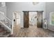 Open-concept living room with wood floors and stylish barn doors at 2387 E Runaway Bay Pl, Gilbert, AZ 85298