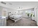 Spacious main bedroom with a ceiling fan, neutral walls, and plenty of natural light at 2387 E Runaway Bay Pl, Gilbert, AZ 85298