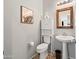 Charming powder room with pedestal sink, framed mirror, cactus art, and decorative floor tiles at 2387 E Runaway Bay Pl, Gilbert, AZ 85298