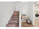 Staircase with carpeted steps, white railing, and decorated console table and decorative accents at 2387 E Runaway Bay Pl, Gilbert, AZ 85298