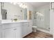Bathroom with white cabinets, quartz countertops and glass enclosed shower at 2511 W Queen Creek Rd # 174, Chandler, AZ 85248