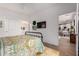 Bright bedroom with a colorful comforter, television and an ensuite bathroom at 2511 W Queen Creek Rd # 174, Chandler, AZ 85248