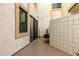 Private courtyard featuring textured walls, tiled floors, and a sliding glass door, perfect for indoor-outdoor living at 2511 W Queen Creek Rd # 174, Chandler, AZ 85248