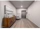 Hallway with art and a wood cabinet leads to an elevator with wood floors at 2511 W Queen Creek Rd # 174, Chandler, AZ 85248