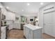 Open-concept kitchen with white cabinetry, stainless steel appliances, and a central island at 2511 W Queen Creek Rd # 174, Chandler, AZ 85248