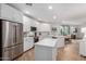 Modern kitchen with white cabinets, stainless steel appliances, island, and wood floors at 2511 W Queen Creek Rd # 174, Chandler, AZ 85248