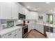 Modern kitchen featuring white cabinets, stainless steel appliances, and sleek countertops at 2511 W Queen Creek Rd # 174, Chandler, AZ 85248