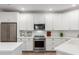 Modern kitchen with white cabinets, stainless steel appliances, and stylish countertops at 2511 W Queen Creek Rd # 174, Chandler, AZ 85248