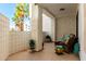 Cozy patio with wicker furniture, textured walls, and decorative potted plants providing a relaxing outdoor space at 2511 W Queen Creek Rd # 174, Chandler, AZ 85248