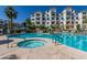 Community pool and spa with turquoise water, surrounded by landscaped grounds and residential buildings at 2511 W Queen Creek Rd # 174, Chandler, AZ 85248