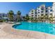 Expansive community pool with clear blue water, poolside lounge chairs, and well-maintained landscaping at 2511 W Queen Creek Rd # 174, Chandler, AZ 85248