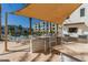 A covered outdoor lounge by a pool area, complete with bar seating and views of a building complex at 2511 W Queen Creek Rd # 174, Chandler, AZ 85248