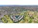 Vast aerial view showcasing a community amidst sparkling lakes and verdant golf courses under clear skies at 2524 S El Paradiso Dr # 82, Mesa, AZ 85202