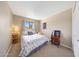 Comfortable bedroom with a window view, carpet flooring, and a decorative accent wall hanging at 2524 S El Paradiso Dr # 82, Mesa, AZ 85202