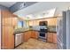 Traditional-style kitchen featuring stainless steel appliances, wood cabinets, and a mosaic backsplash at 2524 S El Paradiso Dr # 82, Mesa, AZ 85202