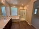 Bathroom featuring a shower, bath, double vanity, and privacy window at 26449 N 84Th Dr, Peoria, AZ 85383