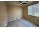 Neutral bedroom with carpeted floor, a ceiling fan and a window for natural light at 26449 N 84Th Dr, Peoria, AZ 85383