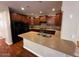 Kitchen features granite countertops, dark wood cabinets, and stainless steel appliances at 26449 N 84Th Dr, Peoria, AZ 85383