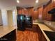 Kitchen features granite countertops, dark wood cabinets, and stainless steel appliances at 26449 N 84Th Dr, Peoria, AZ 85383
