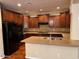 Well-lit kitchen features granite countertops, dark wood cabinets, and stainless steel appliances at 26449 N 84Th Dr, Peoria, AZ 85383