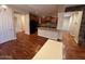 View of the kitchen and living room with hardwood floors and stone fireplace feature at 26449 N 84Th Dr, Peoria, AZ 85383