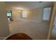 Living room features neutral carpet, large windows, and seamless transitions to other spaces at 26449 N 84Th Dr, Peoria, AZ 85383