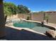 Backyard pool with rock features and a concrete wall border at 26449 N 84Th Dr, Peoria, AZ 85383