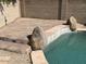 Poolside view features stone accents and surrounding gravel at 26449 N 84Th Dr, Peoria, AZ 85383