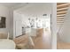 Sunlit living area showcasing open floor plan, modern kitchen, a staircase and a kitchen island with bar stool seating at 312 E Windsor Ave # 13, Phoenix, AZ 85004