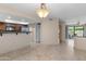Open dining area with travertine floors leading into the kitchen at 3235 E Camelback Rd # 124, Phoenix, AZ 85018