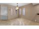 Open dining area featuring travertine floors and modern lighting at 3235 E Camelback Rd # 124, Phoenix, AZ 85018